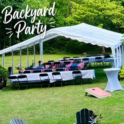 Backyard party setup with a white tent, covered tables, seating, a cocktail table and lawn games