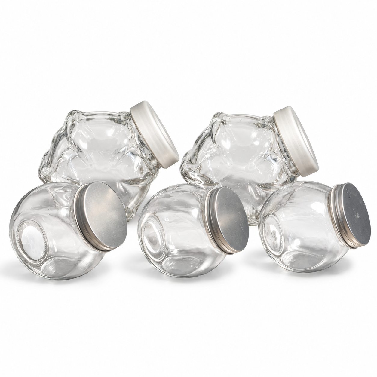 Set of two medium and three small clear glass candy dishes with silver lids on a white background