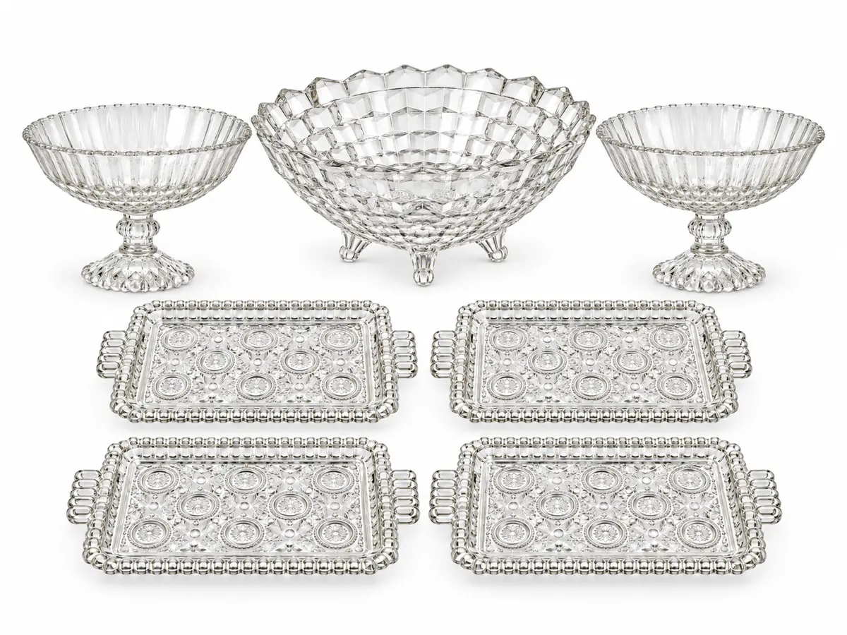 Collection of clear glass serving trays, raised dishes and a serving bowl