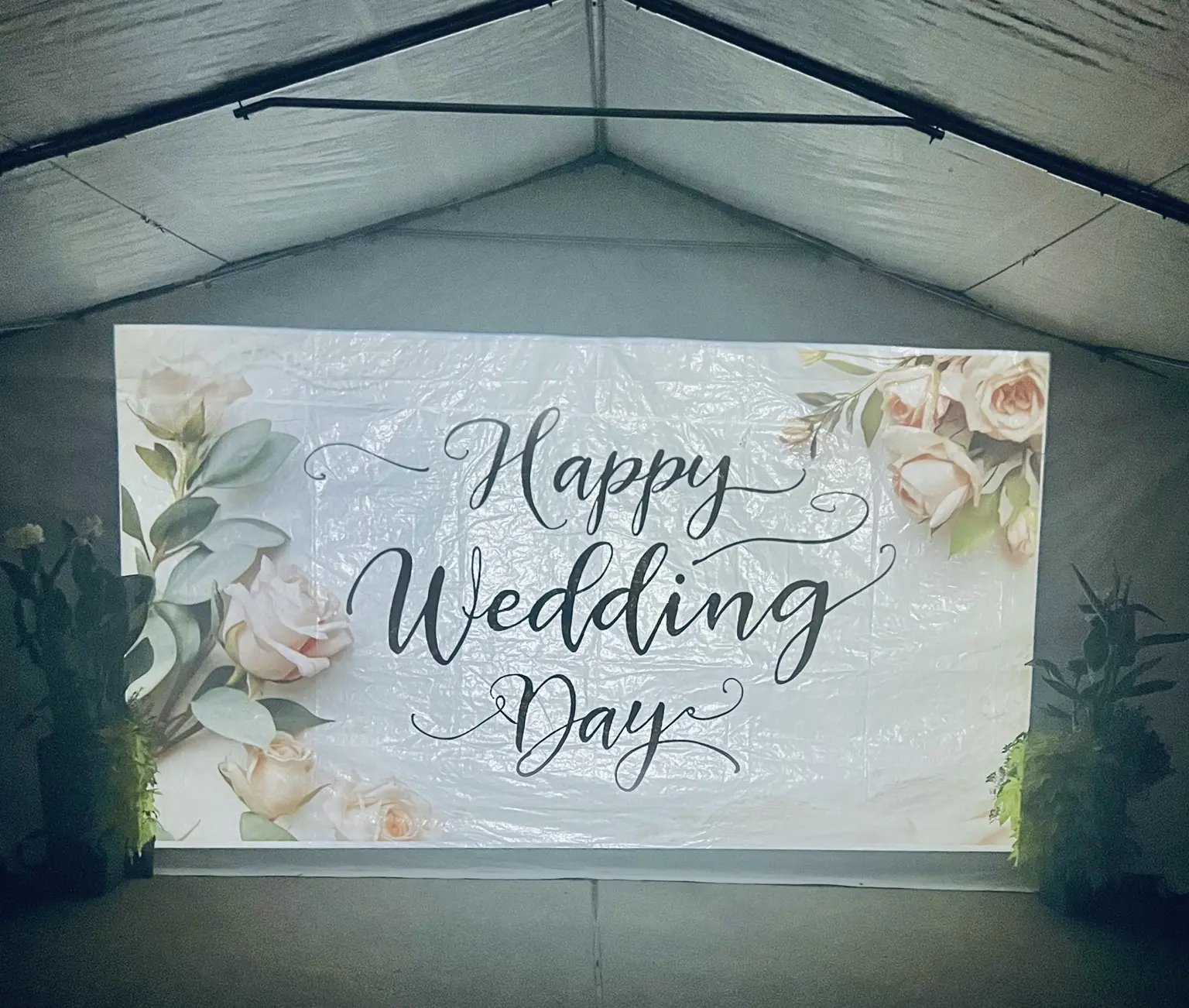 Happy Wedding Day message with flowers projected inside a tent